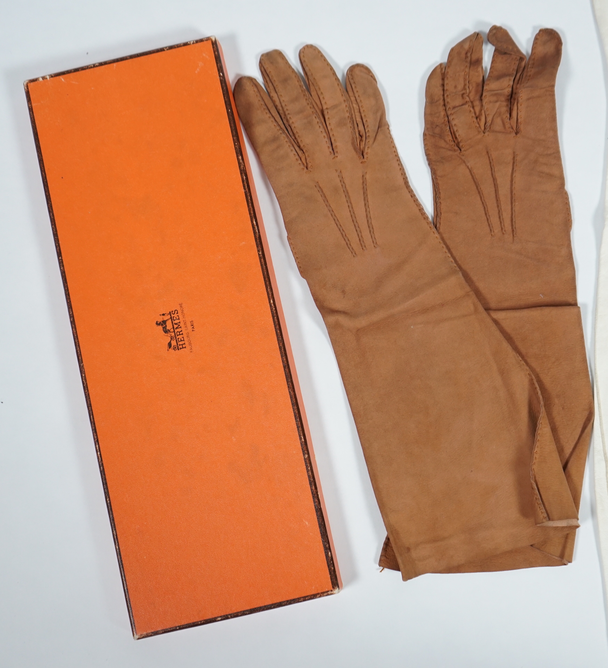 A pair of lady's Hermès skin gloves, boxed and three other pairs of gloves
